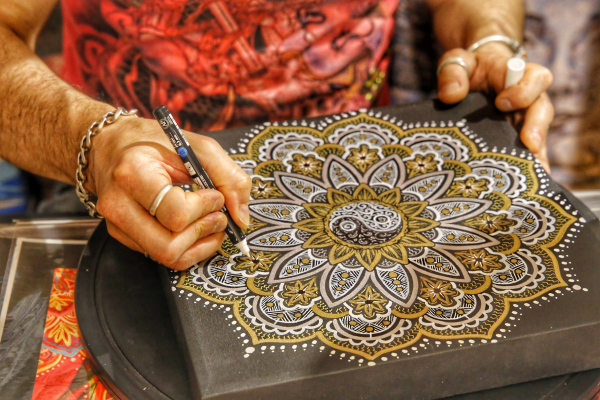 Man drawing a mandala pattern