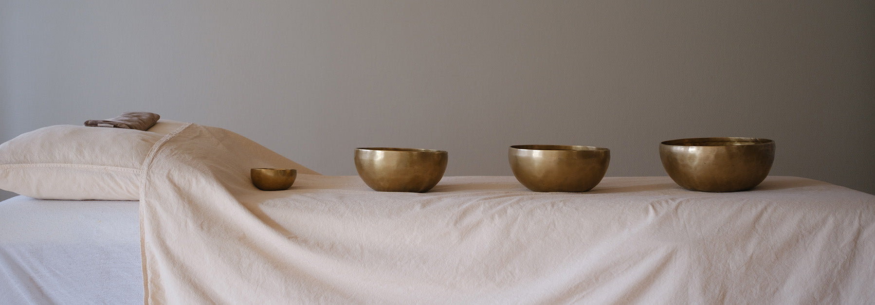 singing bowl sitting upon a cushion on a wooden space