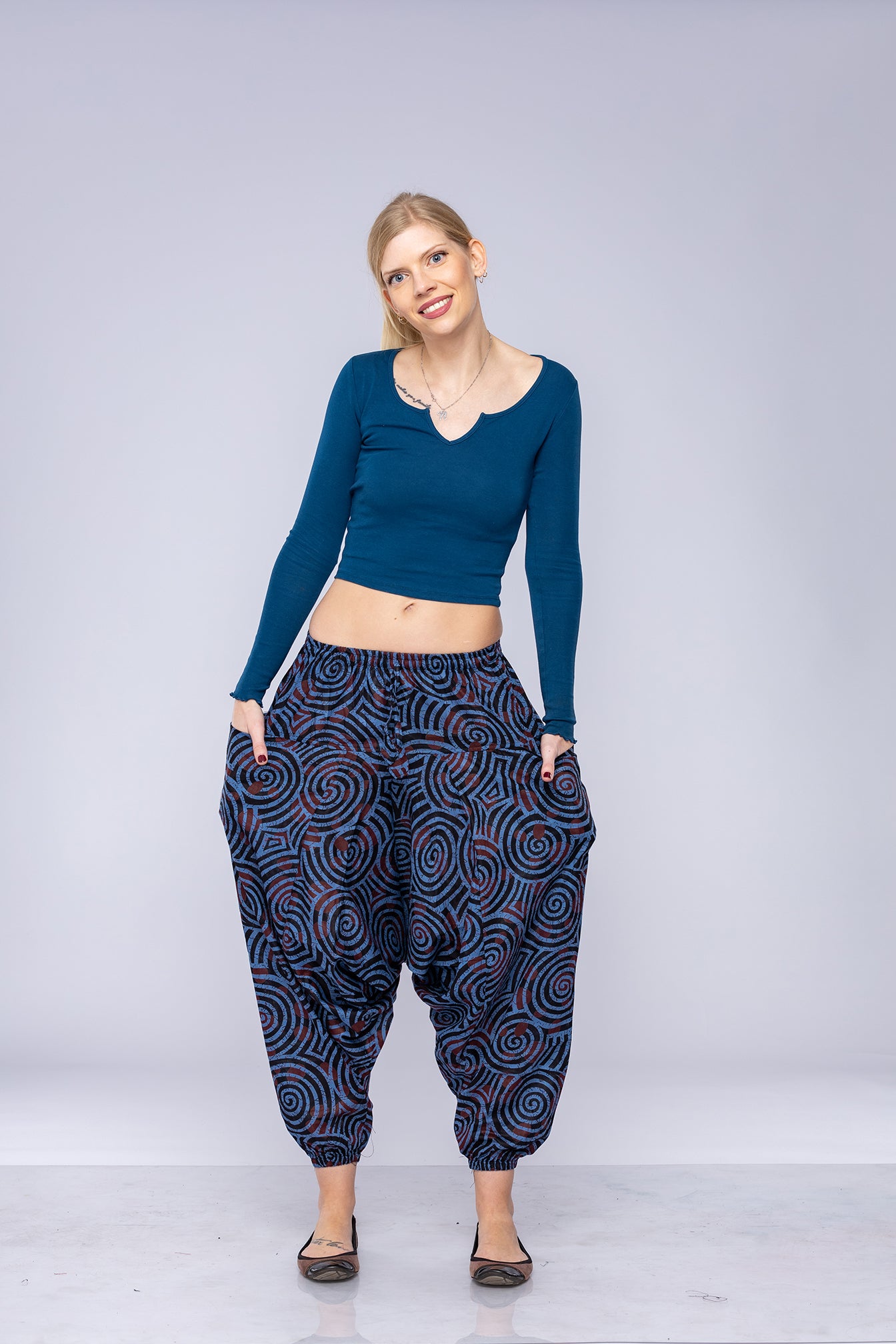 Woman wearing blue Ogee harem pants