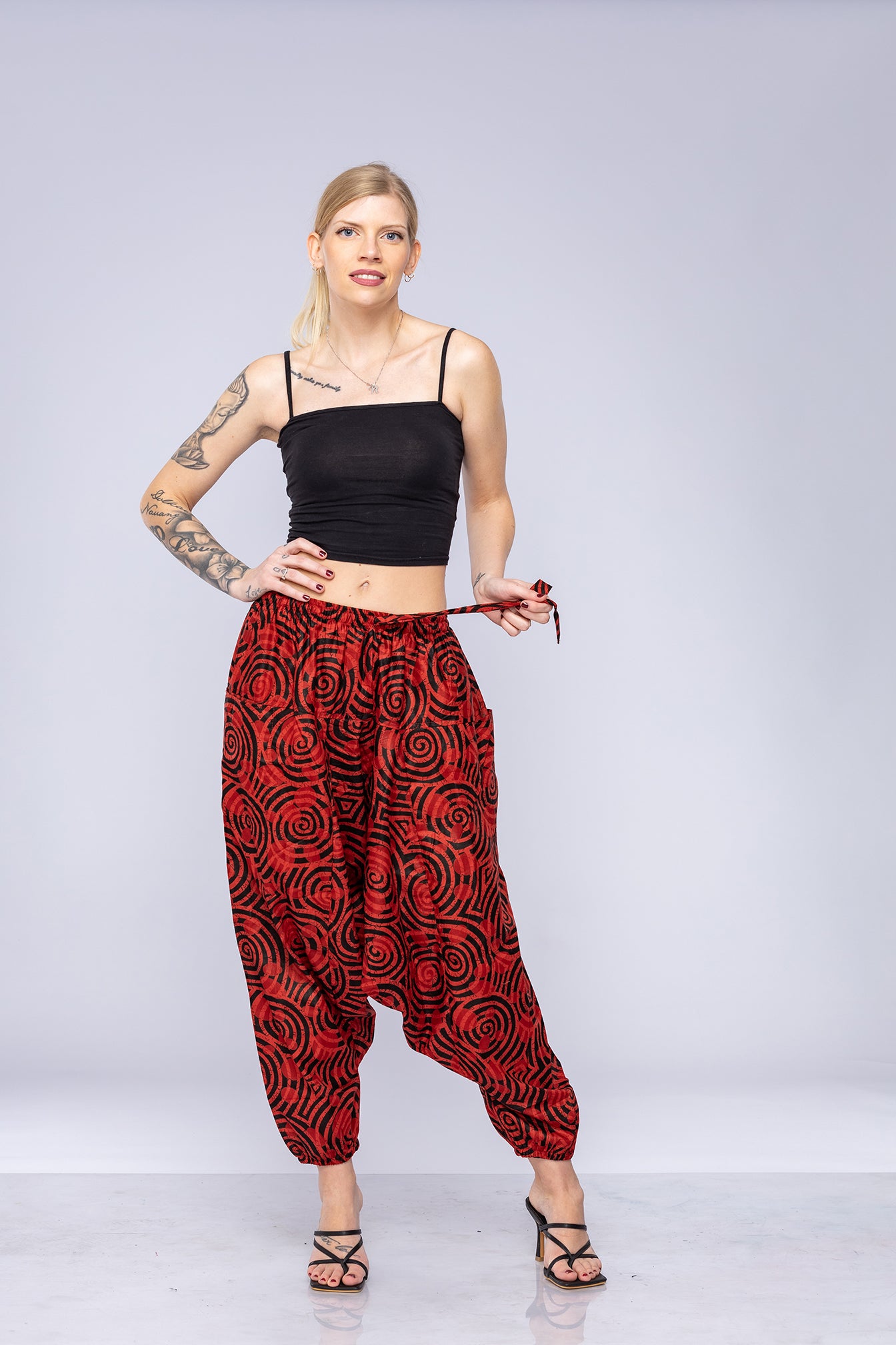 Woman wearing red Ogee harem pants