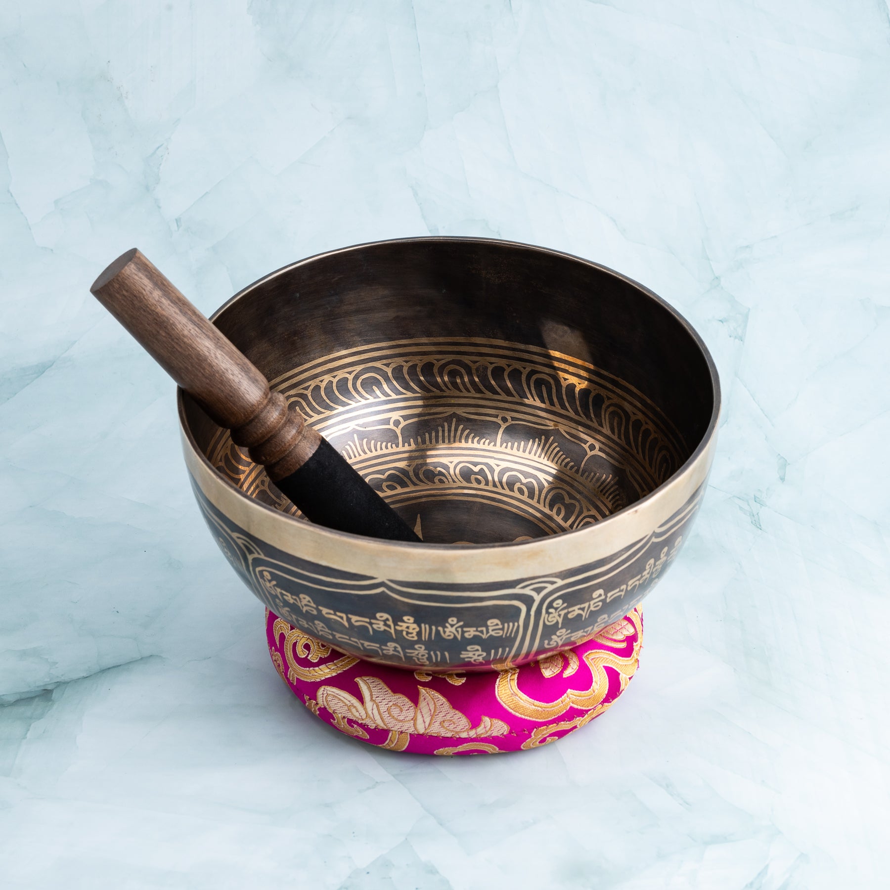 Singing bowl with wooden striker and cushion