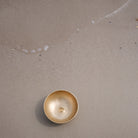 Lingam Singing bowl on a sandy surface