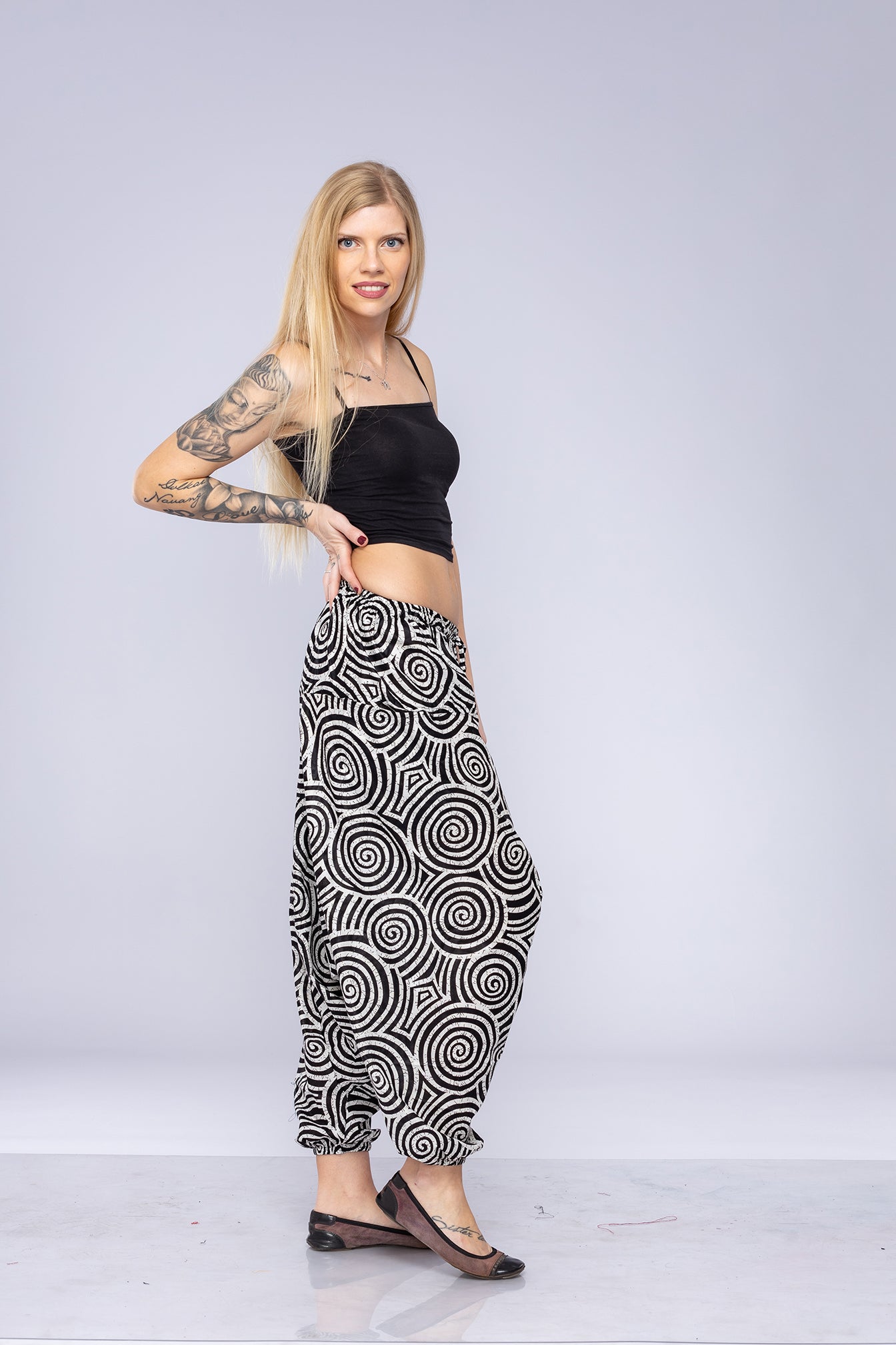 Woman wearing black and white Ogee harem pants