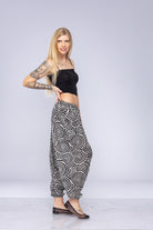 Woman wearing black and white Ogee harem pants