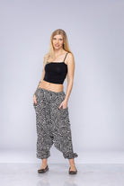 Woman wearing black and white Ogee harem pants