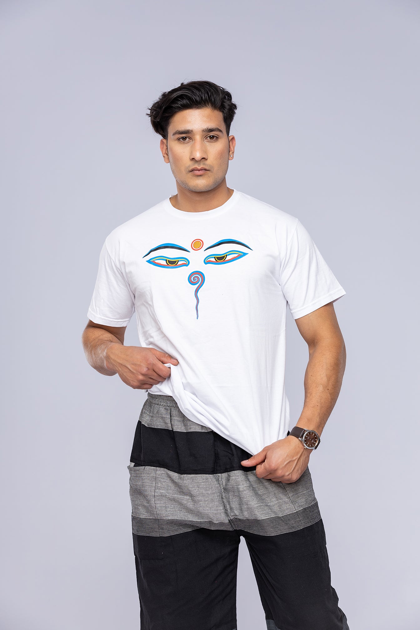 Man modelling a white Eyes of Buddha t-shirt